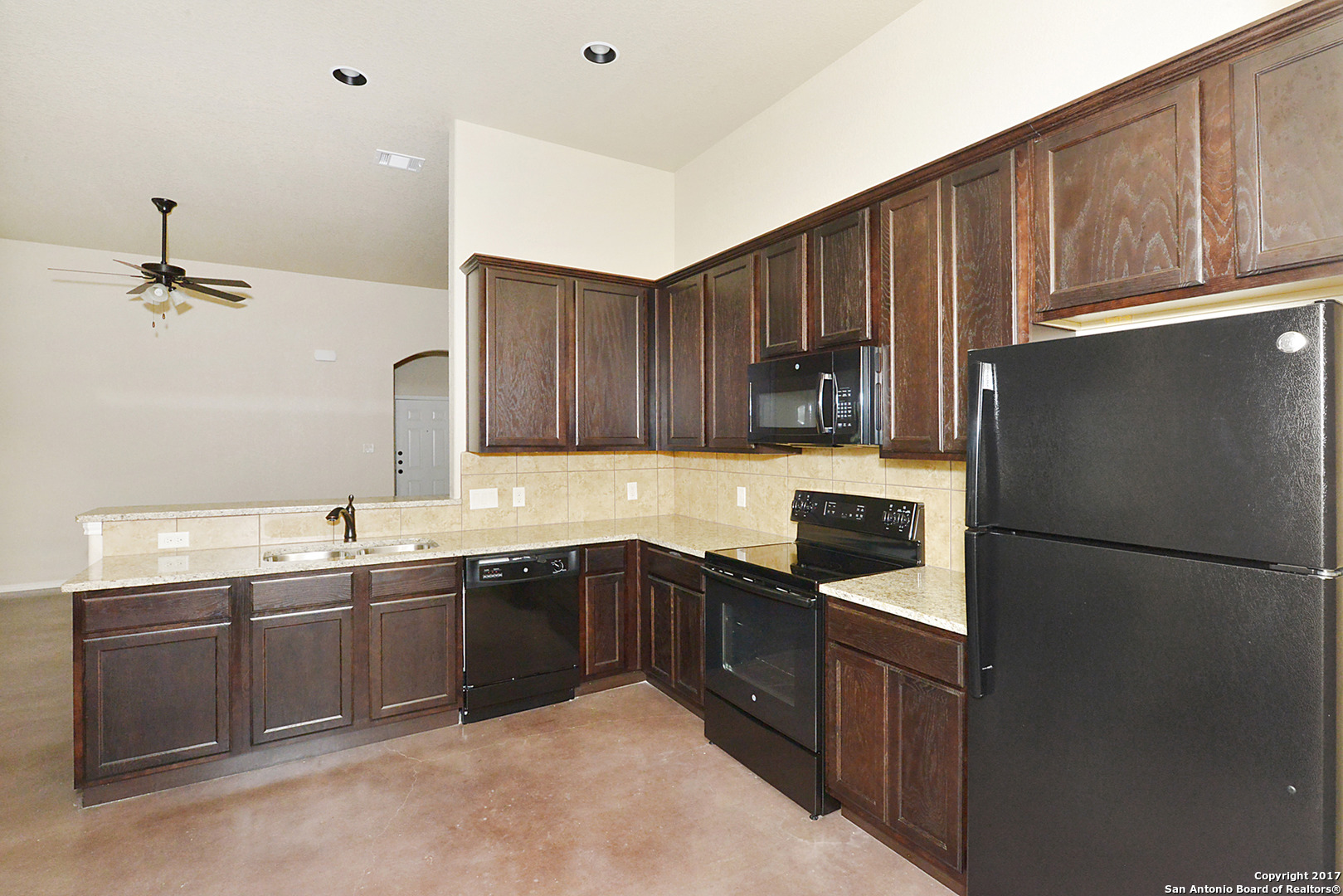 2557 Pahmeyer Road New Braunfels, TX 78130 - Photo 13 of 25 a kitchen with stainless steel appliances granite countertop a sink stove and refrigerator