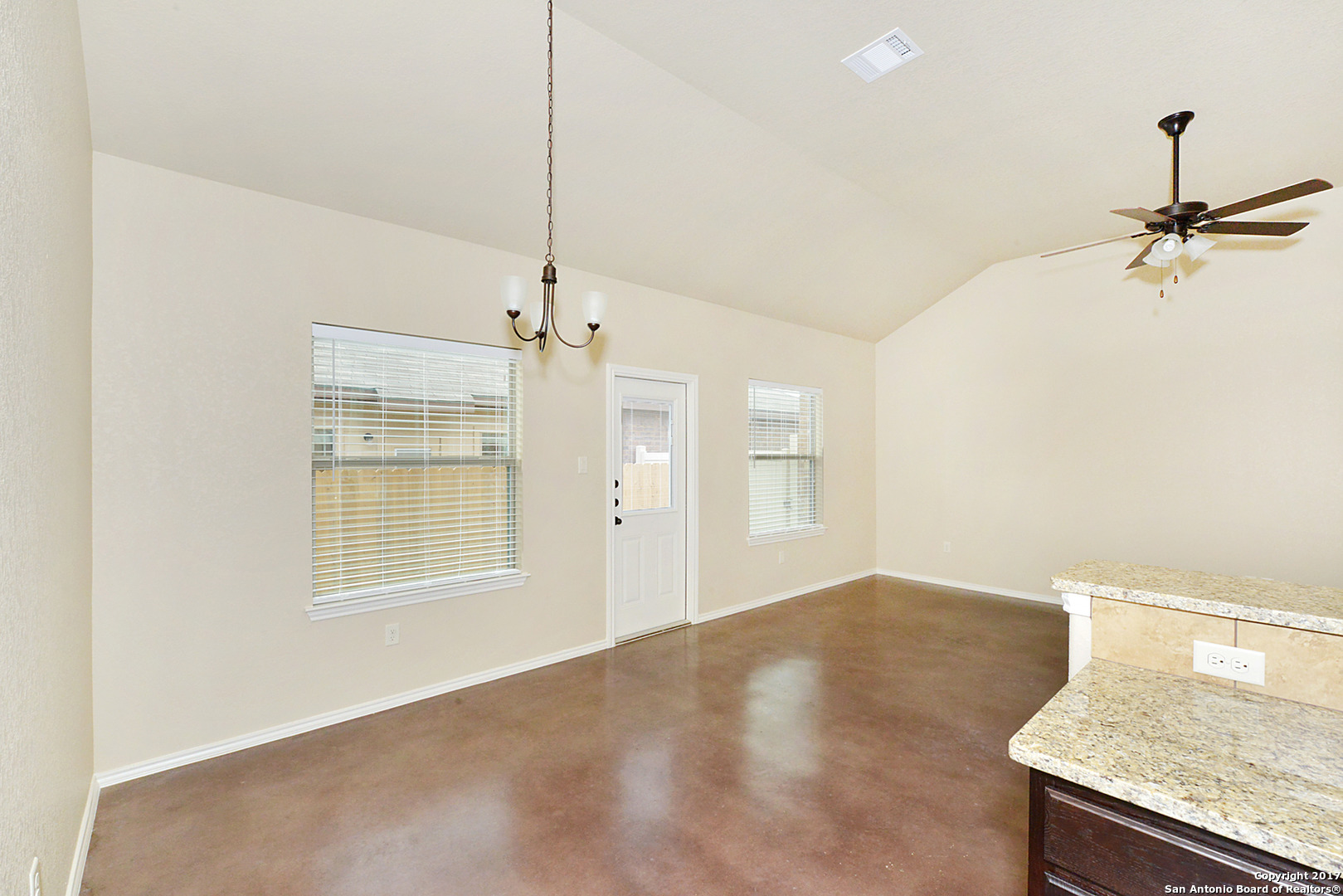 2557 Pahmeyer Road New Braunfels, TX 78130 - Photo 14 of 25 a view of a kitchen with a sink and a chandelier