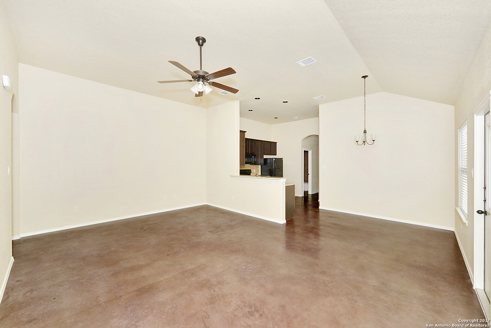 2557 Pahmeyer Road New Braunfels, TX 78130 - Photo 9 of 25 a view of a kitchen with a refrigerator and a ceiling fan