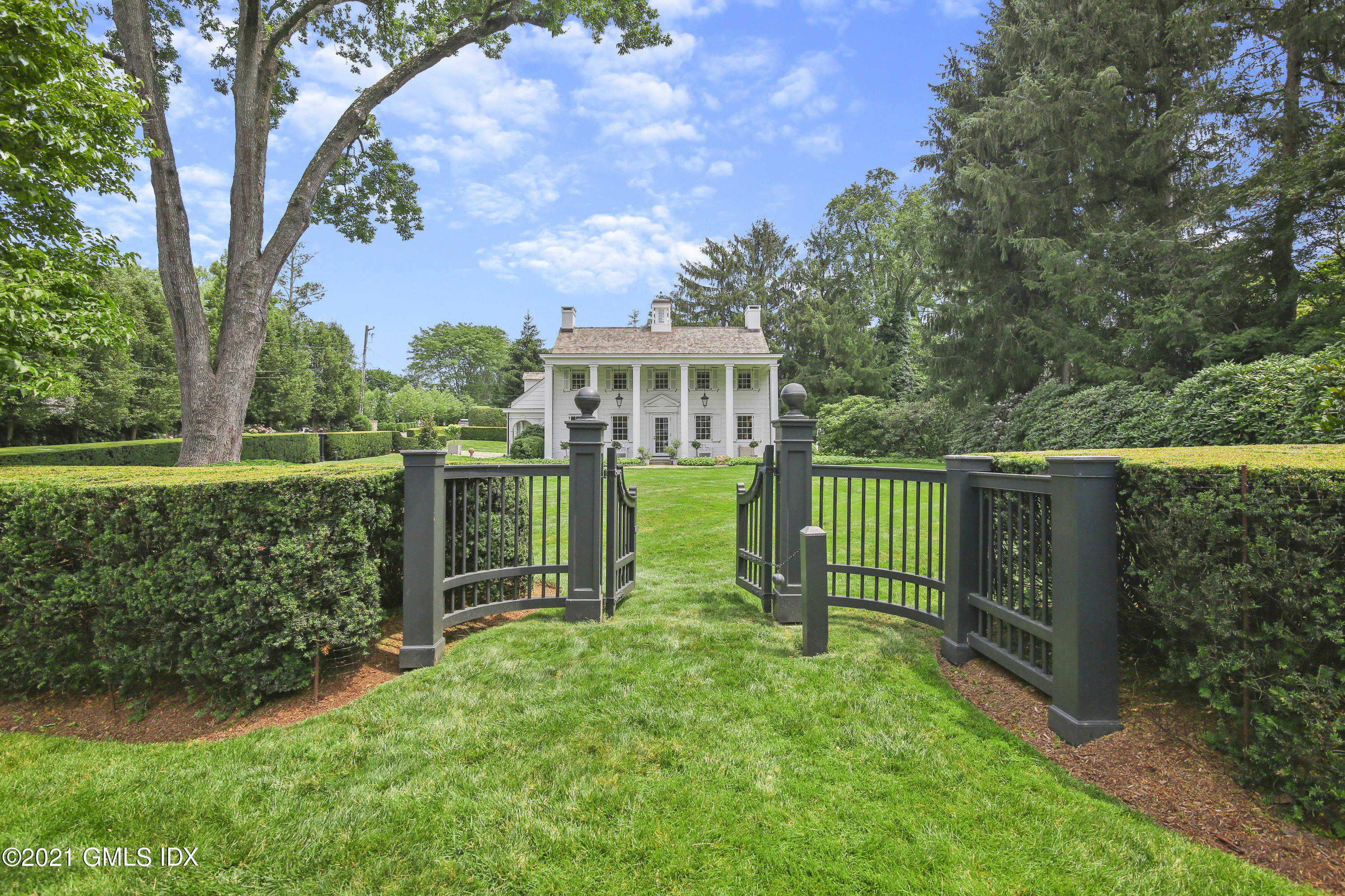 a view of a house with a backyard and a tree