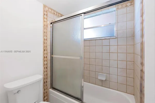 a bathroom with a shower and a toilet