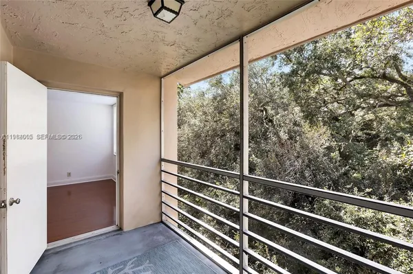 a view of a room with wooden floor and windows