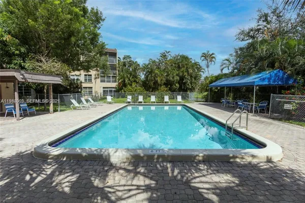 a swimming pool with outdoor seating and yard