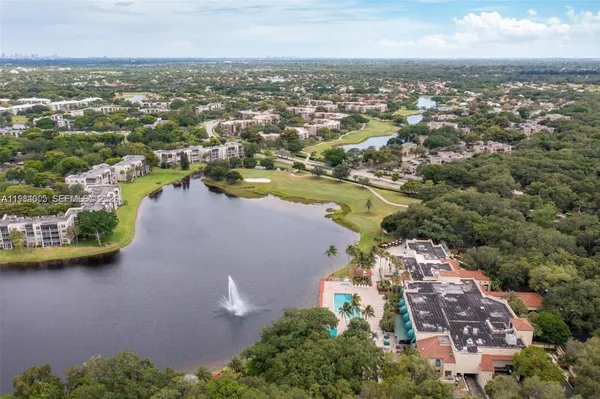 an aerial view of residential houses with outdoor space and lake view