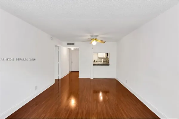 a view of a room with wooden floor