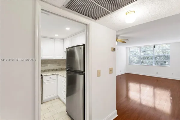 a kitchen with a refrigerator and a window