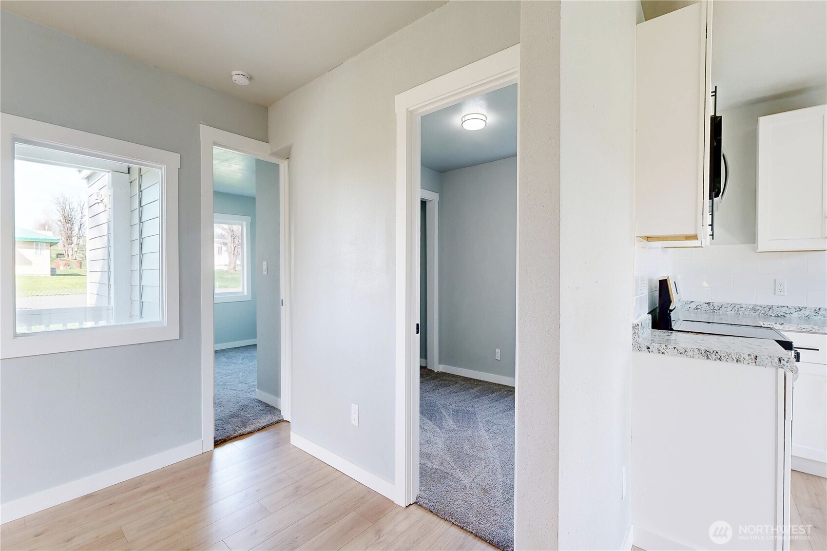 255 College Street Adams, OR 97810 - Photo 11 of 31 a view of a kitchen with a sink dishwasher and wooden floor