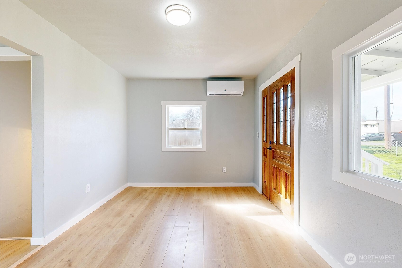 255 College Street Adams, OR 97810 - Photo 3 of 31 an empty room with wooden floor and windows