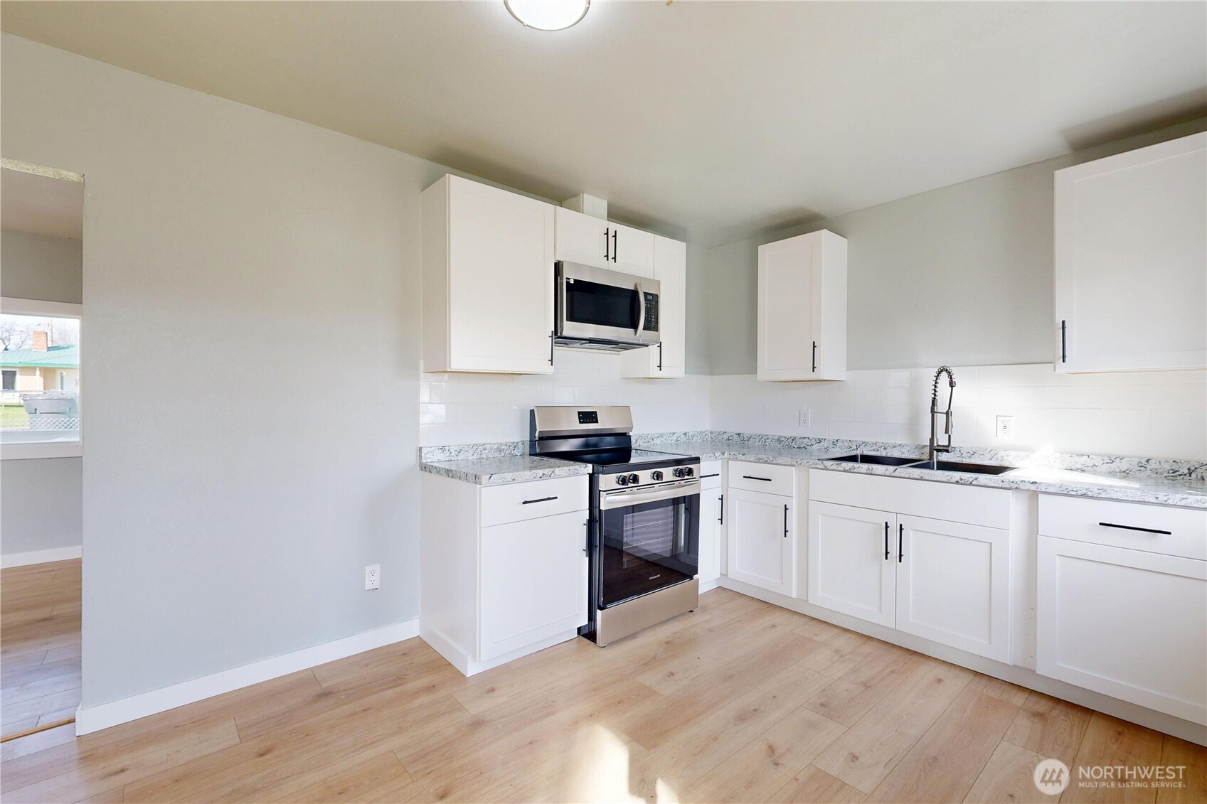 255 College Street Adams, OR 97810 - Photo 8 of 31 a kitchen with granite countertop a stove top oven sink and cabinets