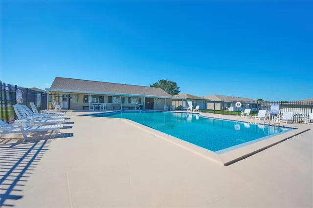 a view of swimming pool with chairs