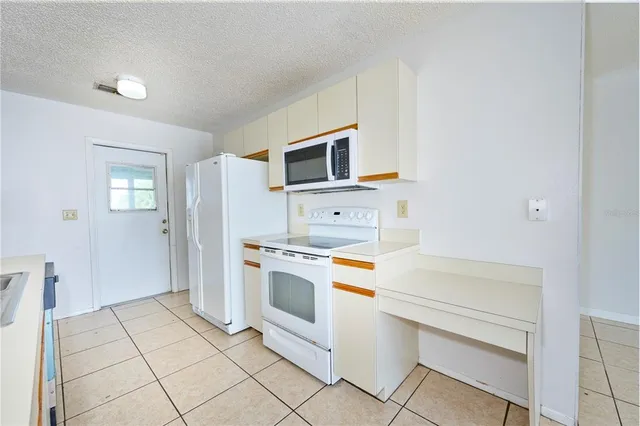 a kitchen with a stove top oven and cabinets