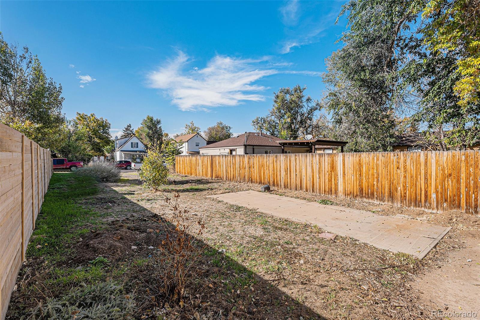 3976 South Acoma Street Englewood, CO 80110 - Photo 9 of 23 a backyard of a house with a table and chairs