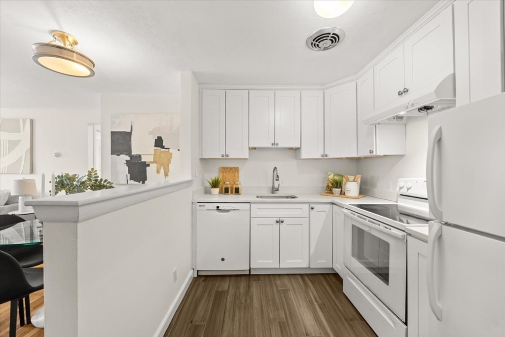 a kitchen with cabinets appliances and a counter space