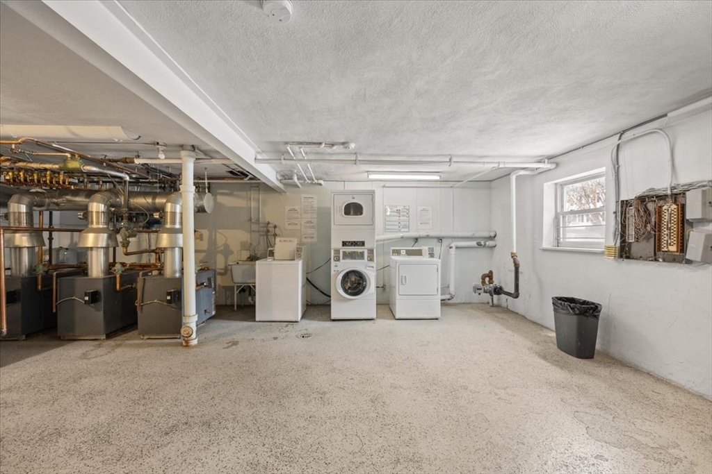 51 Warren Street, Unit 13 Waltham, MA 02453 - Photo 15 of 16 a view of a storage & utility room with washer and dryer