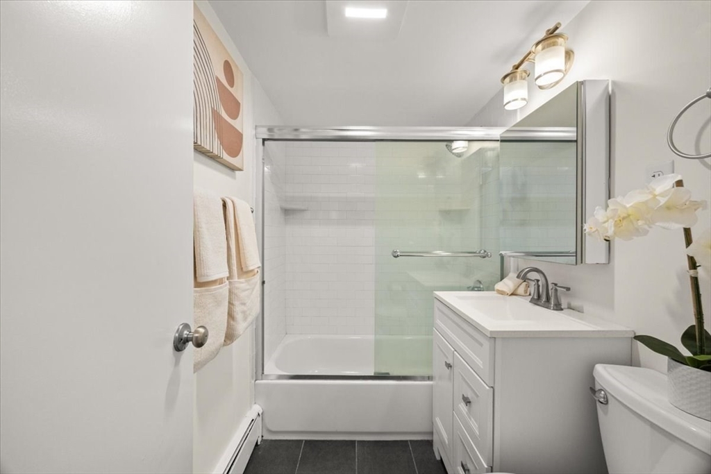 51 Warren Street, Unit 13 Waltham, MA 02453 - Photo 6 of 16 a bathroom with a sink a toilet and shower