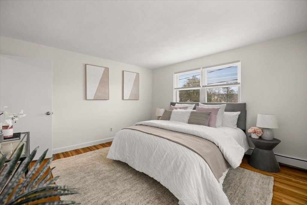 51 Warren Street, Unit 13 Waltham, MA 02453 - Photo 8 of 16 a bedroom with a bed and a window