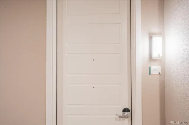 a kitchen with a refrigerator and a stove top oven