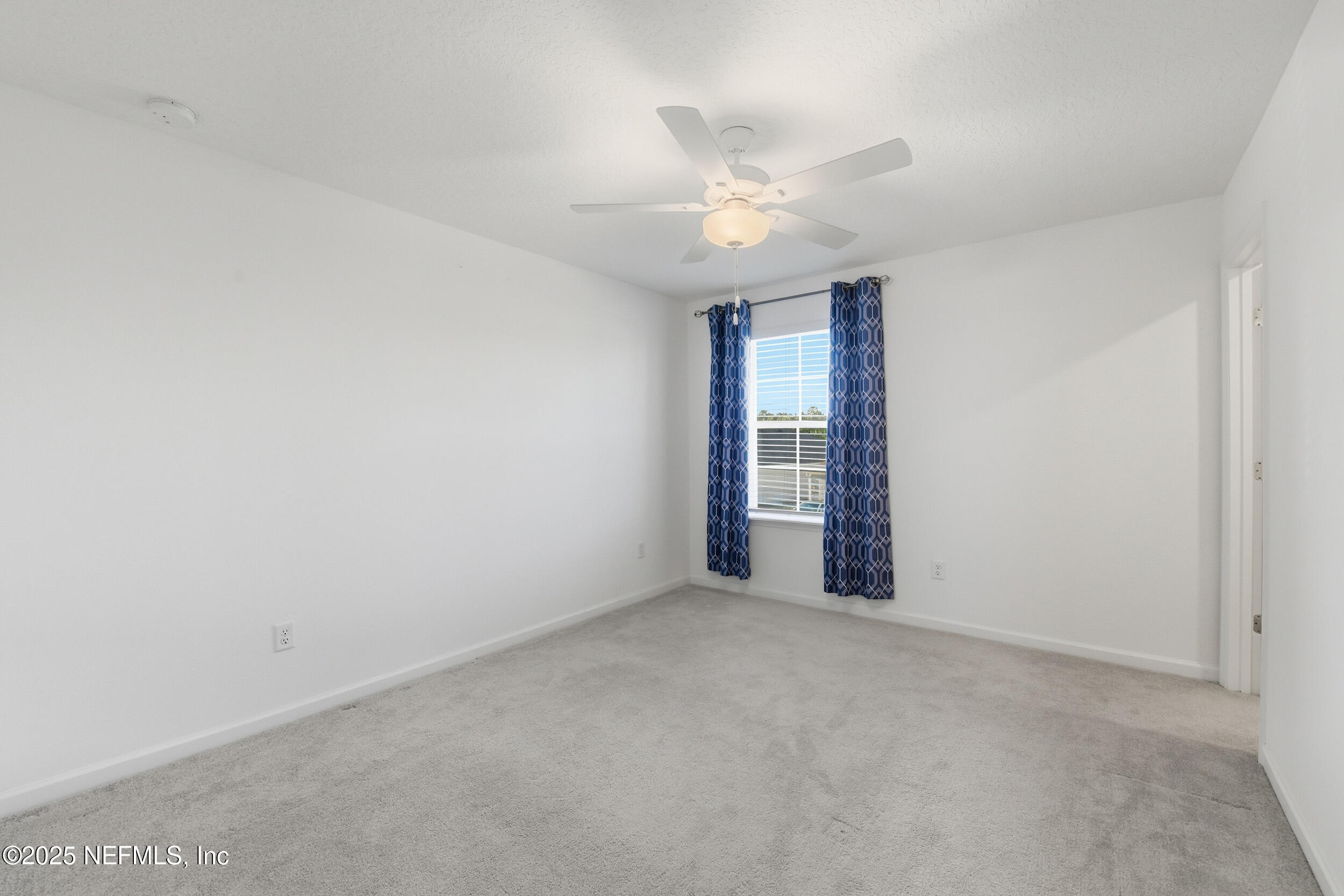 9852 Lemon Balm Way Jacksonville, FL 32219 - Photo 16 of 45 an empty room with windows and fan