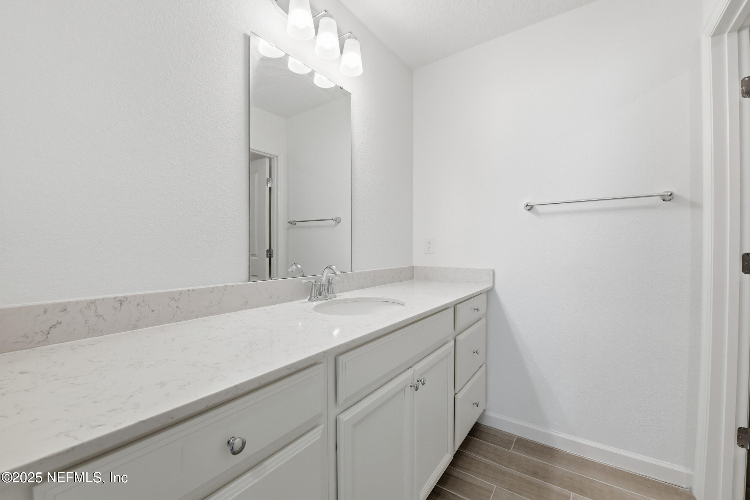 9852 Lemon Balm Way Jacksonville, FL 32219 - Photo 17 of 45 a bathroom with a sink and a mirror