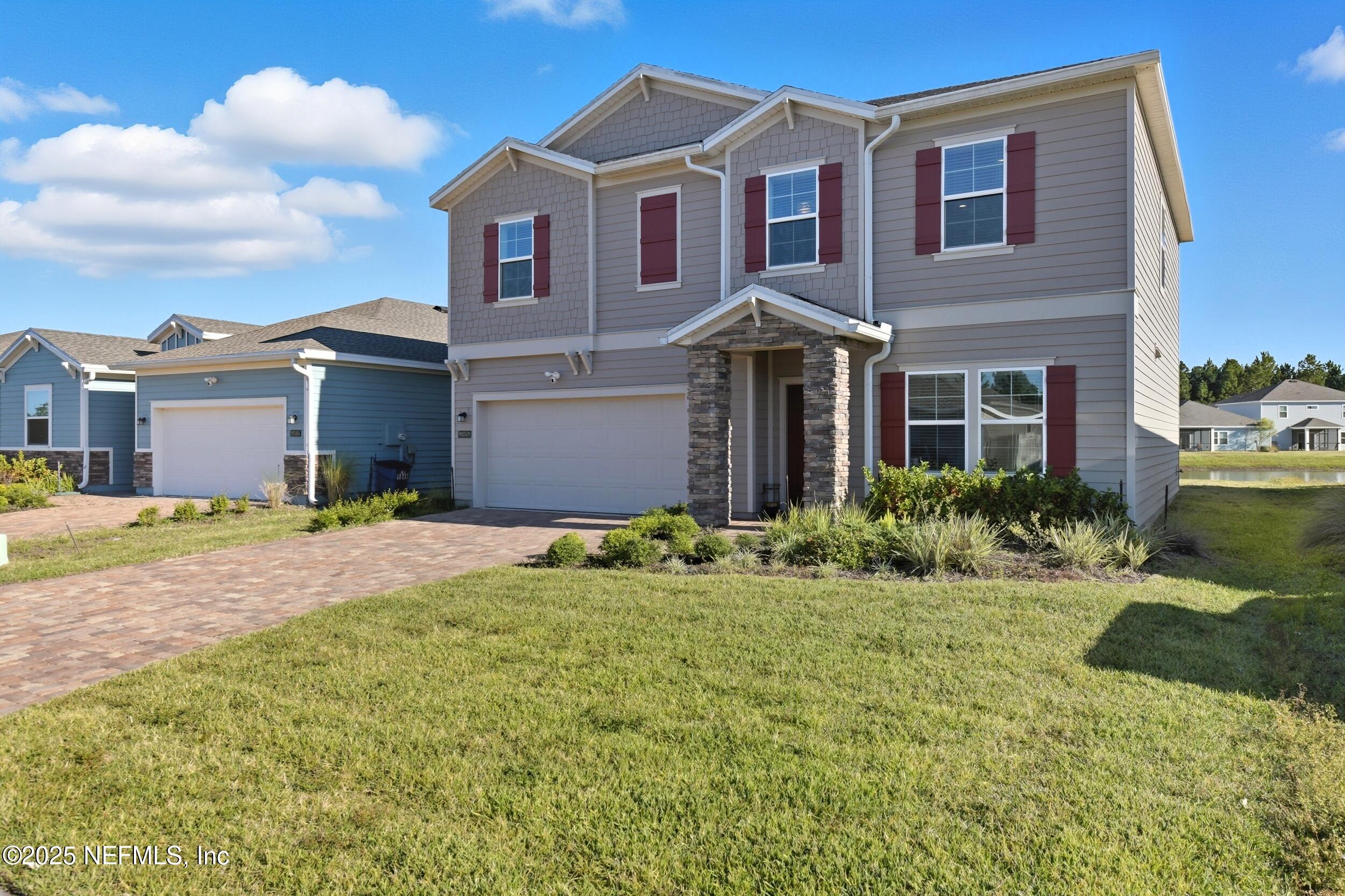 9852 Lemon Balm Way Jacksonville, FL 32219 - Photo 27 of 45 a front view of a house with a yard