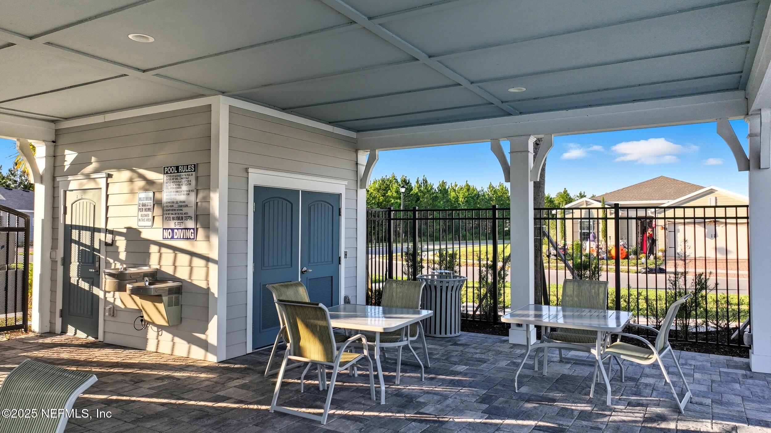 9852 Lemon Balm Way Jacksonville, FL 32219 - Photo 42 of 45 a view of a patio with table and chairs