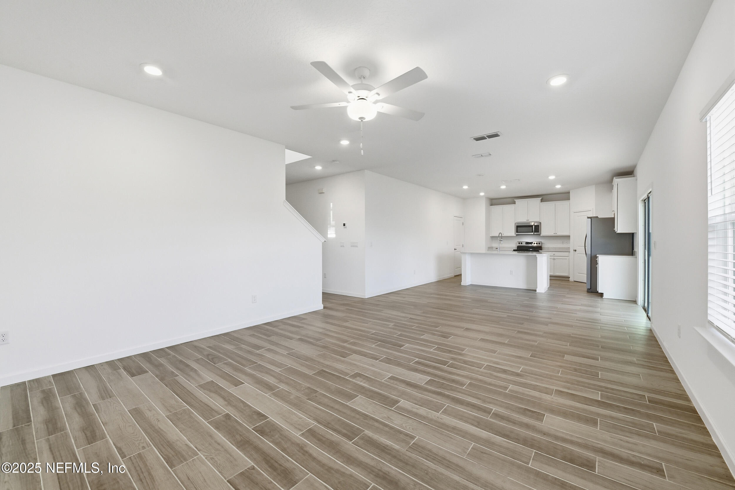9852 Lemon Balm Way Jacksonville, FL 32219 - Photo 6 of 45 a view of empty room with wooden floor