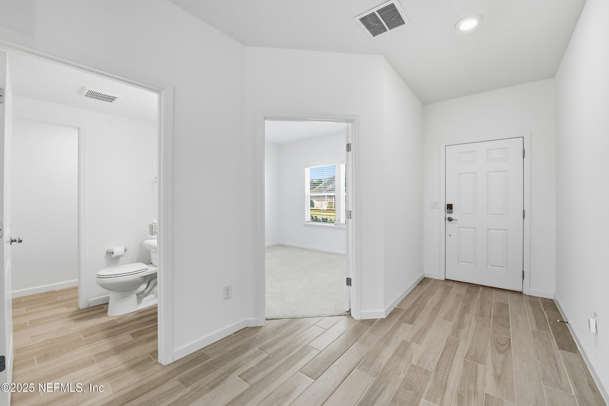 9852 Lemon Balm Way Jacksonville, FL 32219 - Photo 7 of 45 a view of a bathroom with wooden floor and a toilet