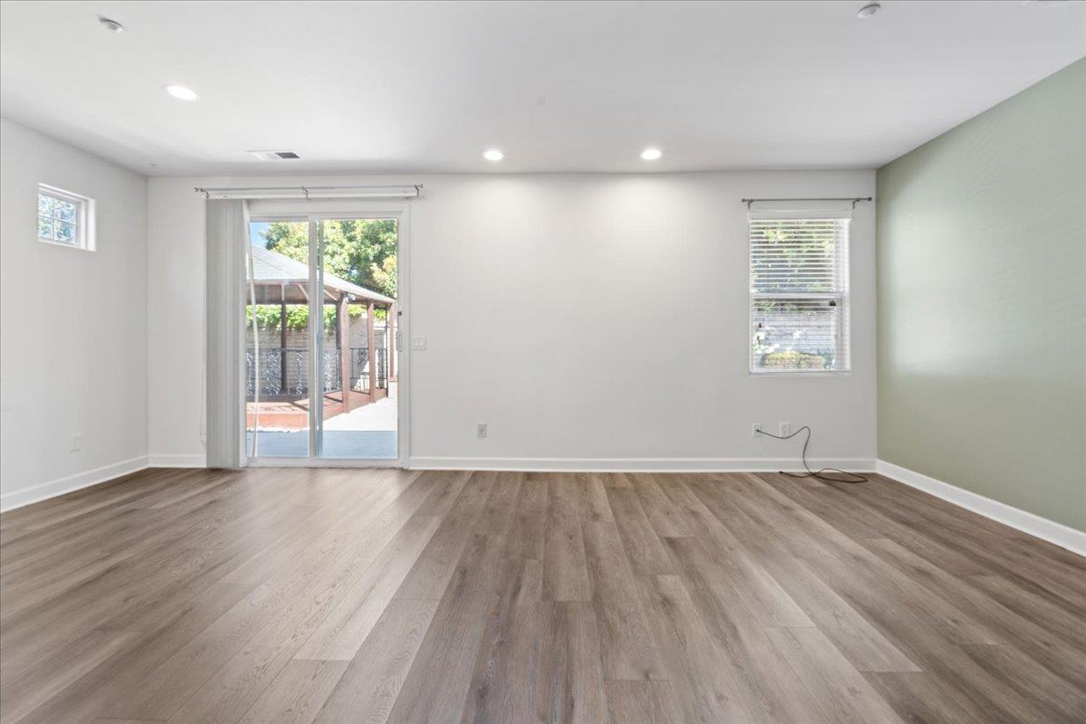 478 Churchill Way Salinas, CA 93906 - Photo 3 of 31 an empty room with wooden floor and windows
