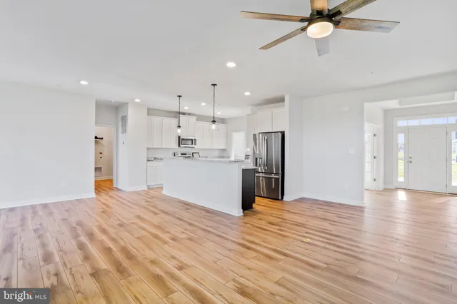 a large kitchen with cabinets and stainless steel appliances