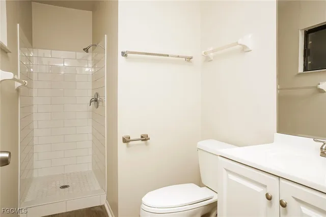 a white toilet sitting next to a bathroom sink
