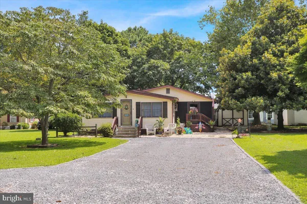a front view of a house with swimming pool and yard