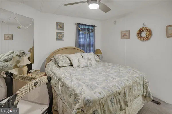 a bedroom with furniture and a large window