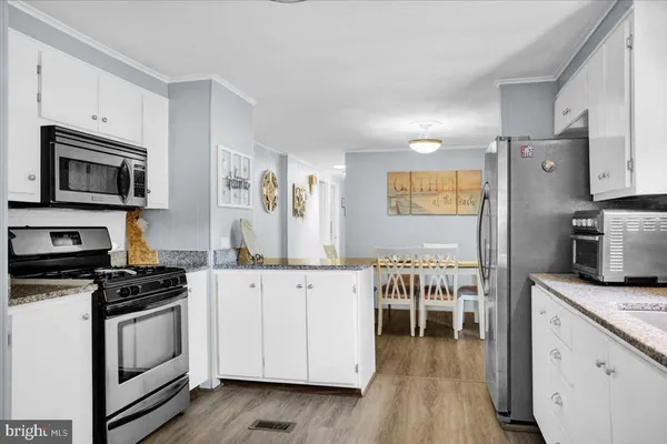 a bedroom with furniture and a wooden floor