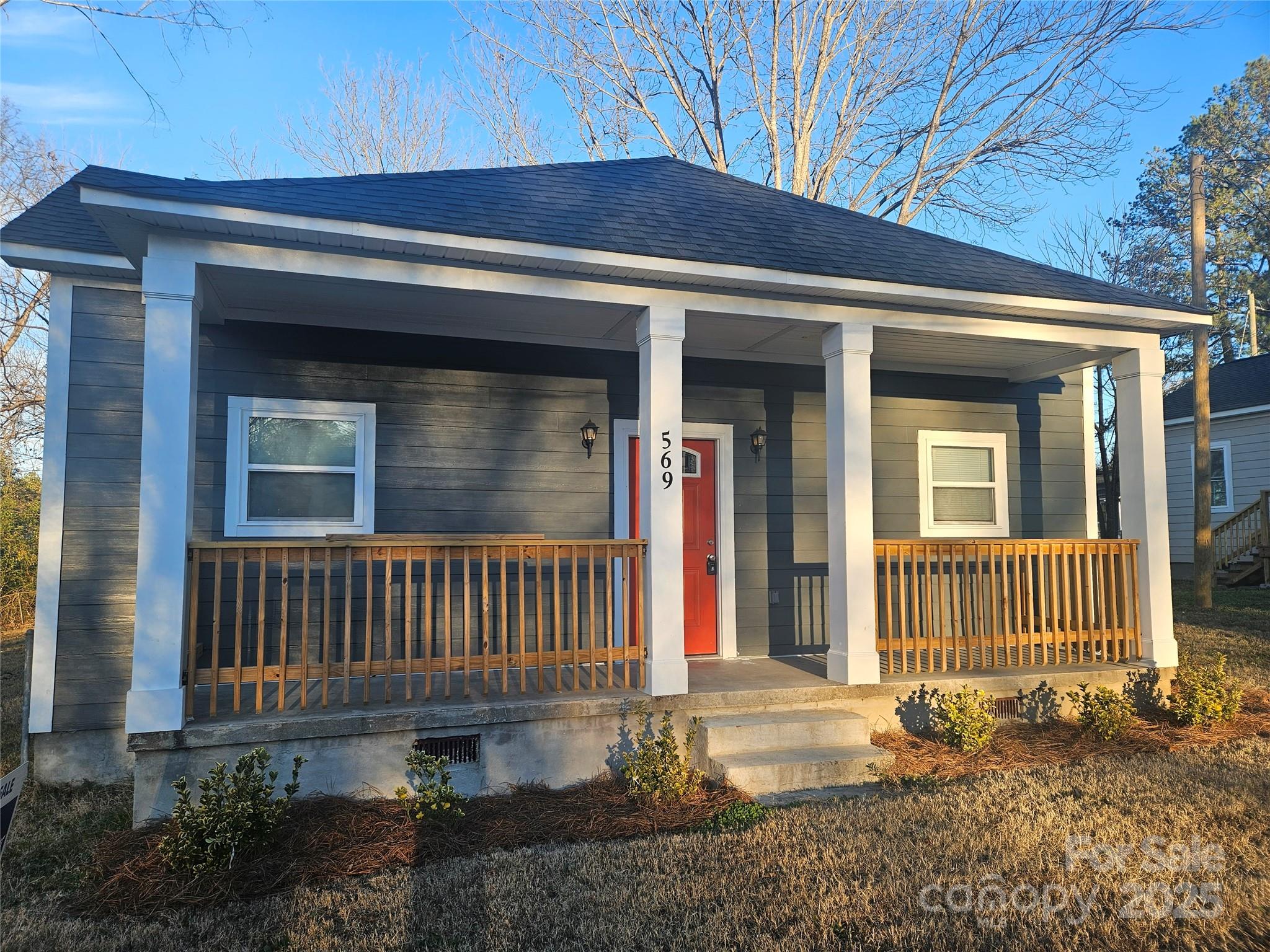 a front view of a house with a garden