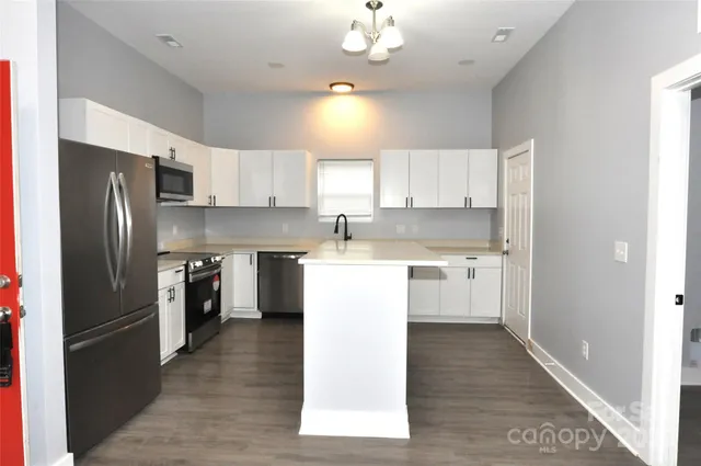 a kitchen with a refrigerator a sink and dishwasher