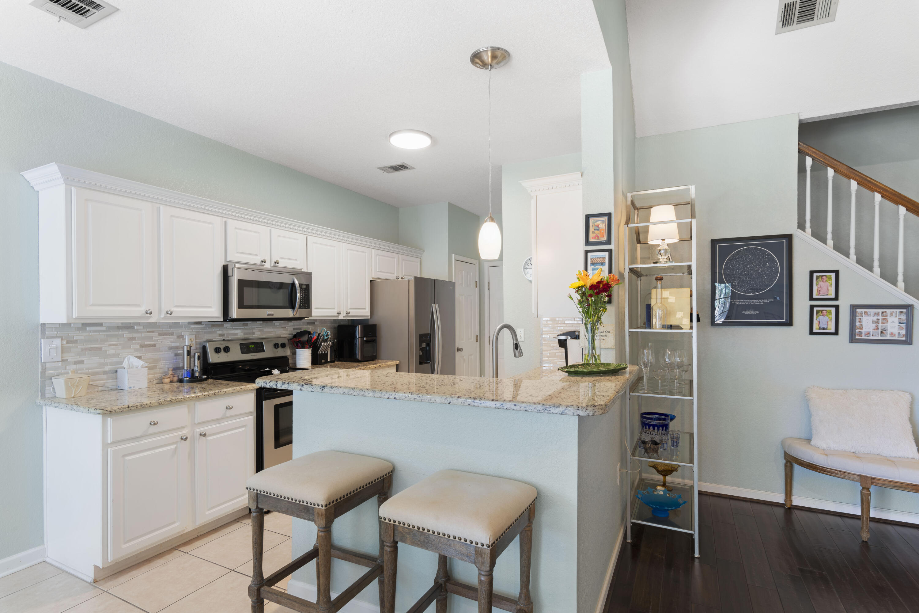 159 Mariner Way Miramar Beach, FL 32550 - Photo 13 of 47 a kitchen with stainless steel appliances granite countertop a refrigerator a stove top oven a sink dishwasher and white cabinets with wooden floor
