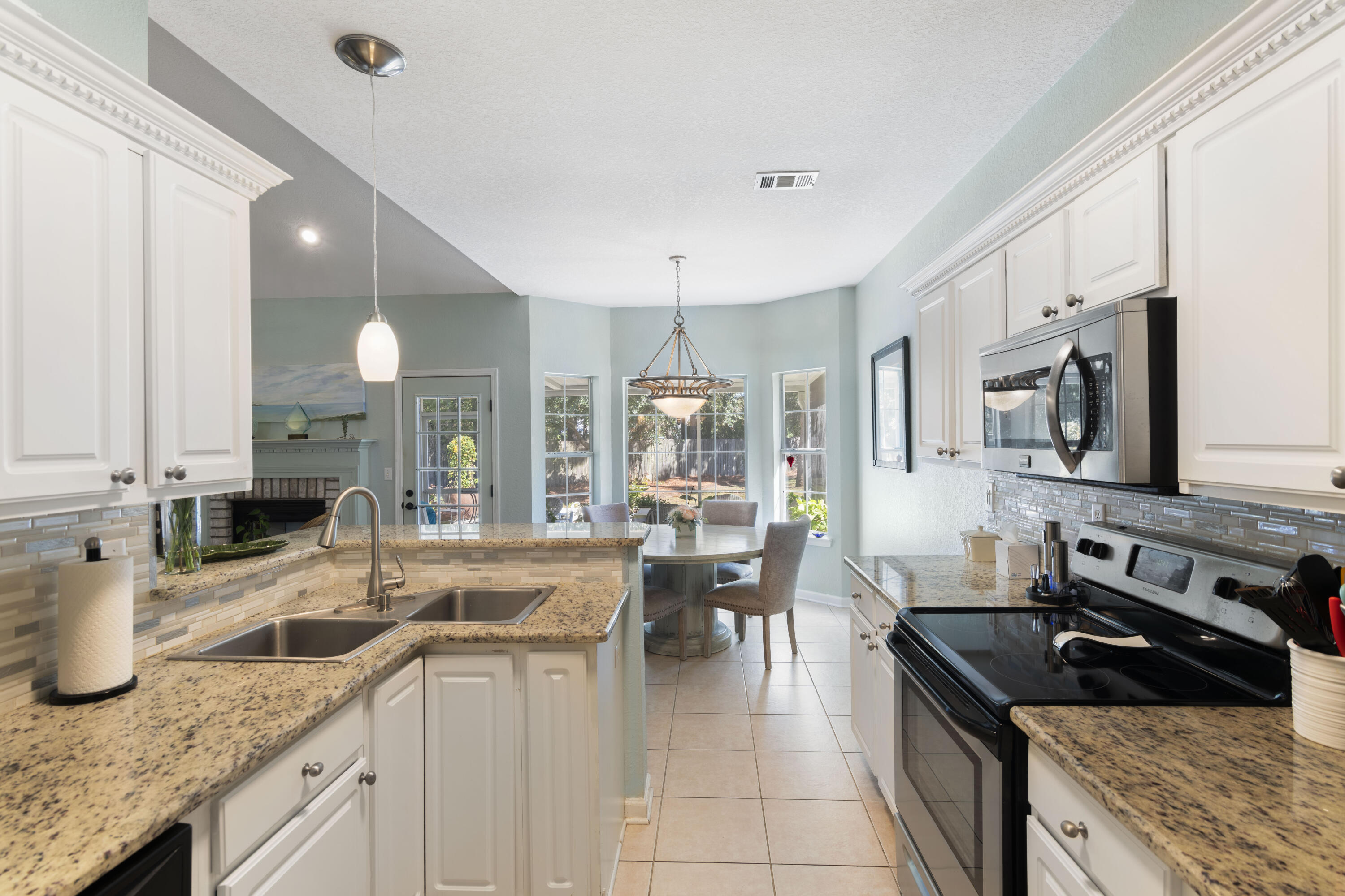 159 Mariner Way Miramar Beach, FL 32550 - Photo 16 of 47 a kitchen with stainless steel appliances granite countertop a sink stove and cabinets