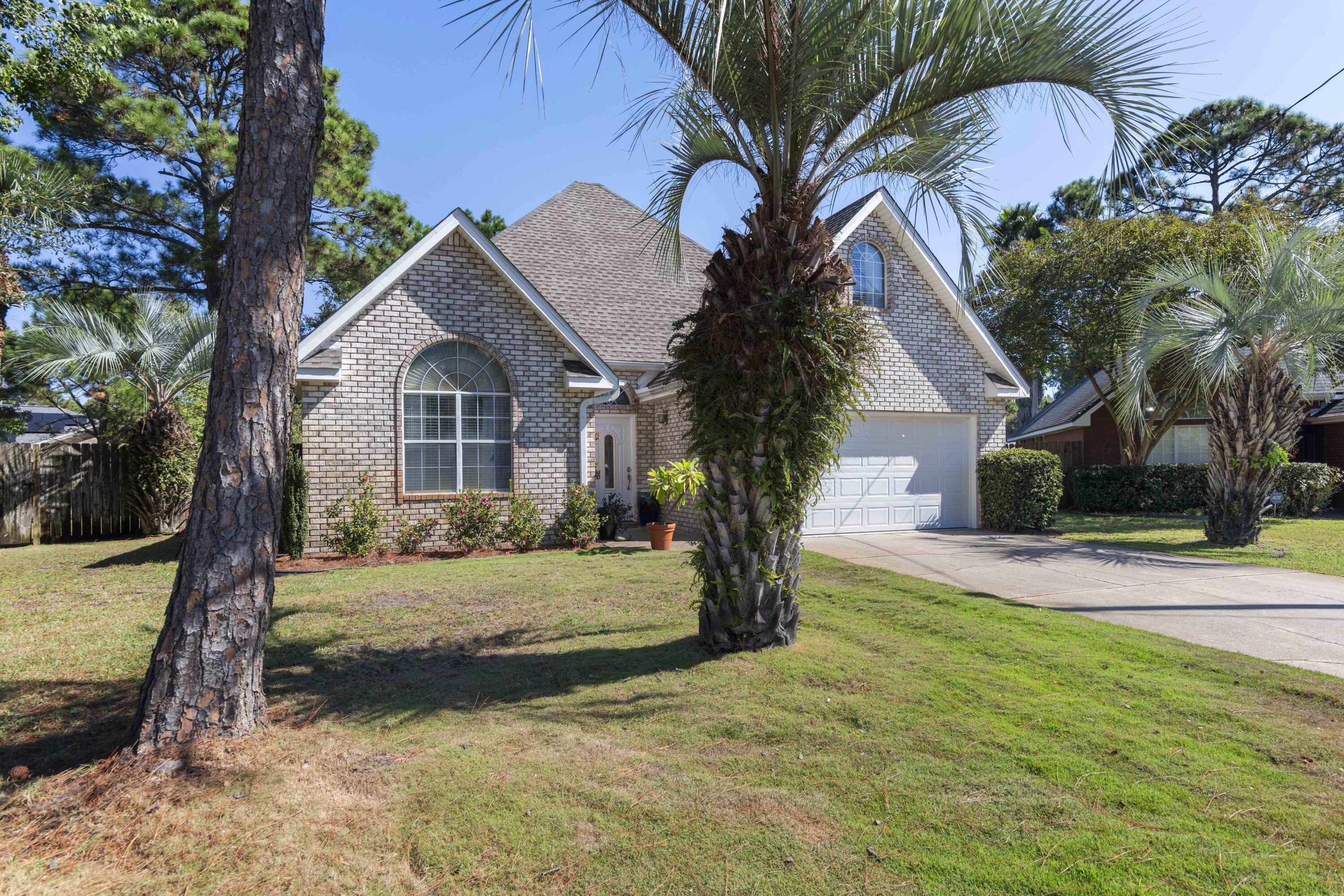 159 Mariner Way Miramar Beach, FL 32550 - Photo 2 of 47 a front view of a house with a yard garage and outdoor seating