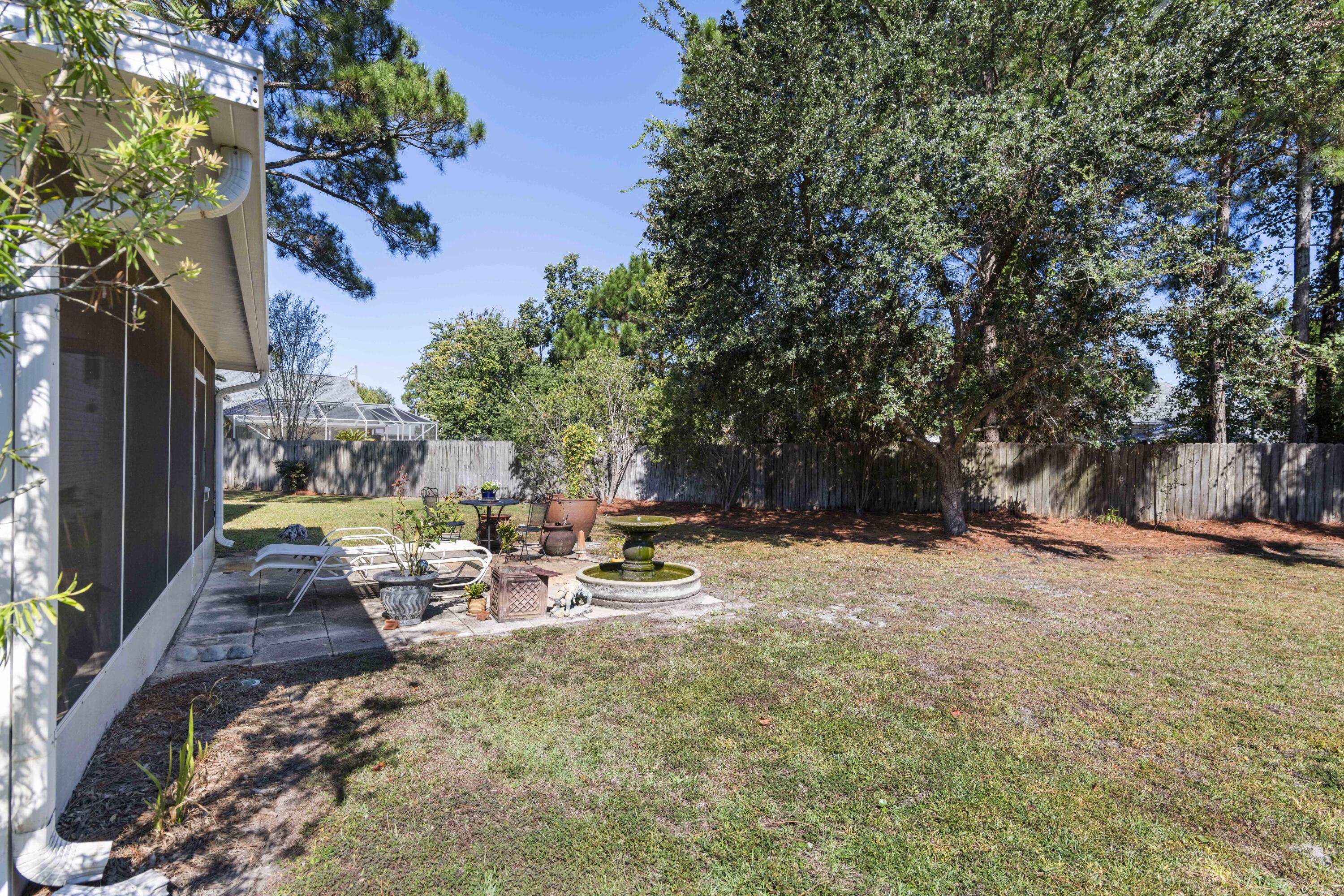 159 Mariner Way Miramar Beach, FL 32550 - Photo 28 of 47 a view of backyard with a table and chairs and wooden fence