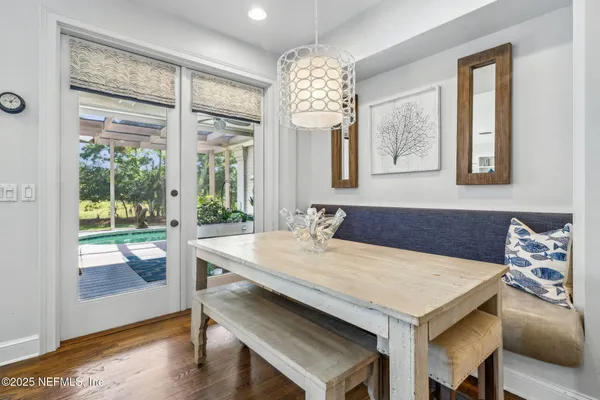 a spacious bedroom with a bed a table and a large window