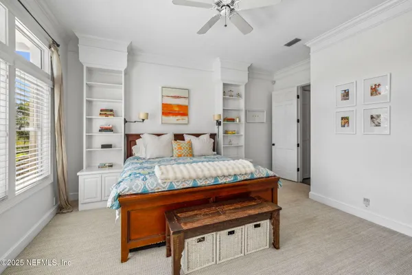 a bedroom with a bed and flat screen tv