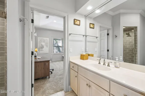 a bathroom with a sink a toilet and a large mirror
