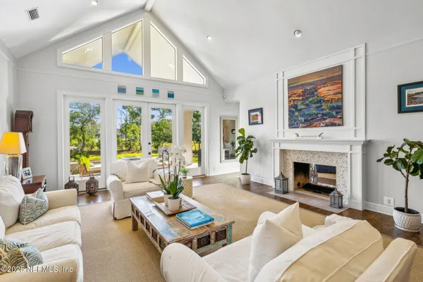 a kitchen with stainless steel appliances kitchen island granite countertop a wooden floor and white cabinets