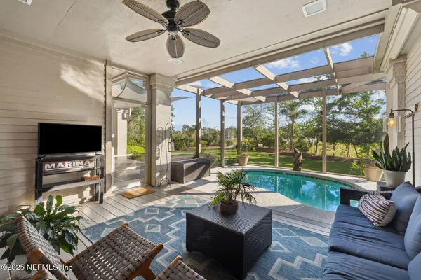 a living room with furniture a fireplace and a potted plant