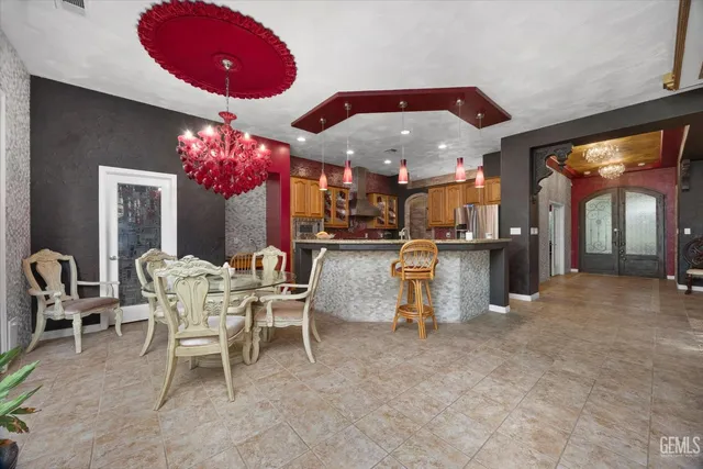 a view of a dining room with furniture and chandelier