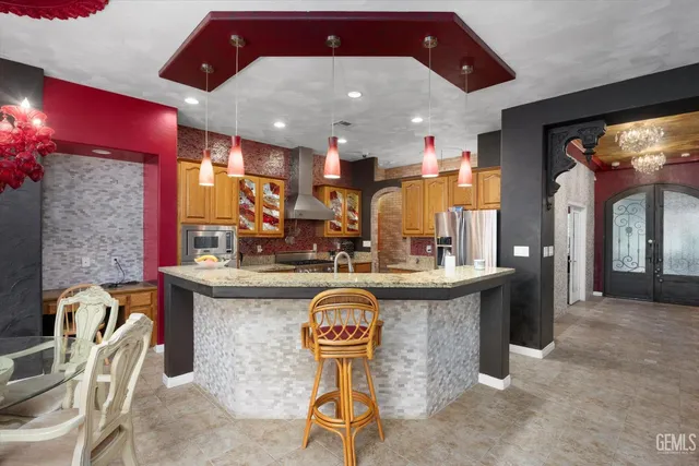 a kitchen with stainless steel appliances granite countertop a sink and a wooden cabinets