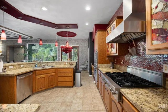 a kitchen with stainless steel appliances granite countertop a stove and a sink