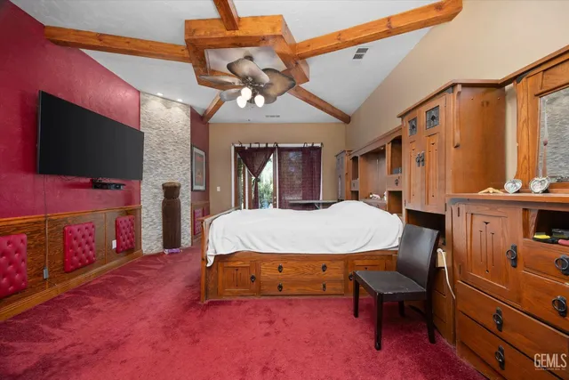 a spacious bedroom with a bed and a flat screen tv