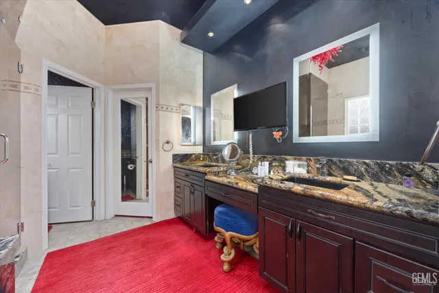 a kitchen with a sink cabinets and a wooden floor