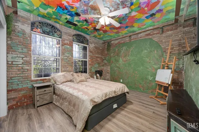 a bed sitting in a bedroom next to a window